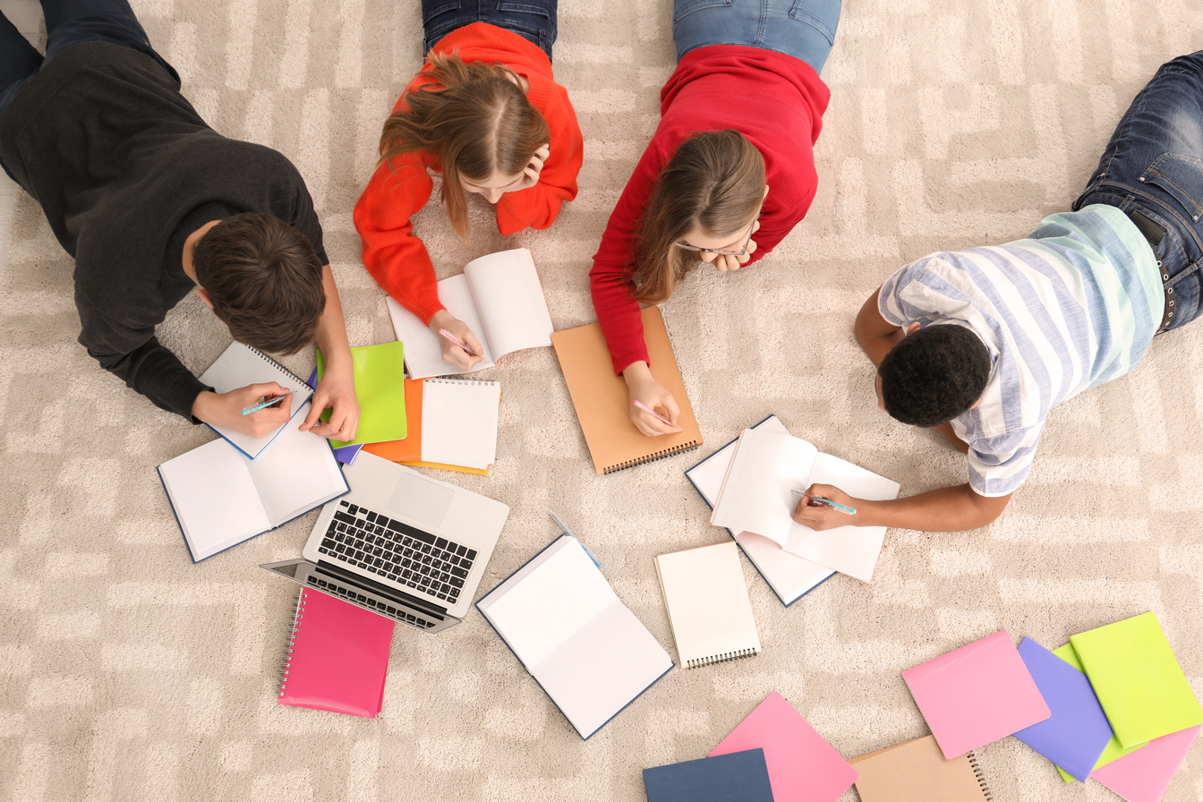 Group of Teenagers Doing Homework on Floor